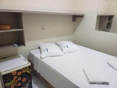 Uma cama ou camas num quarto em Pousada Dragao Do Mar