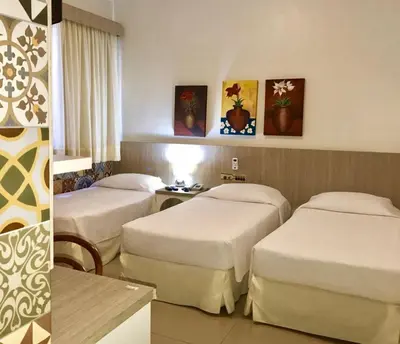 Uma cama ou camas num quarto em Aldeota Praia Hotel