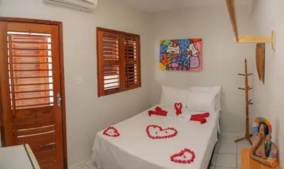 Uma cama ou camas num quarto em Pousada Jerimar