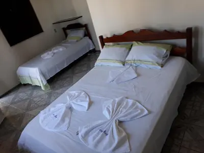 Uma cama ou camas num quarto em Pousada Aconchego