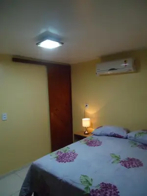 Uma cama ou camas num quarto em Pousada do Turista