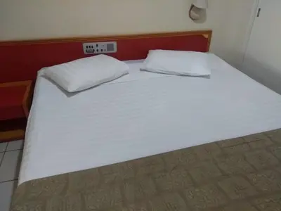 Uma cama ou camas num quarto em Ocean Tower Fortaleza