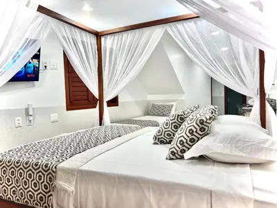 Uma cama ou camas num quarto em Rede Andrade Dunas
