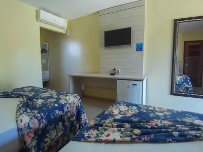 Uma cama ou camas num quarto em Jardim dos Orixás