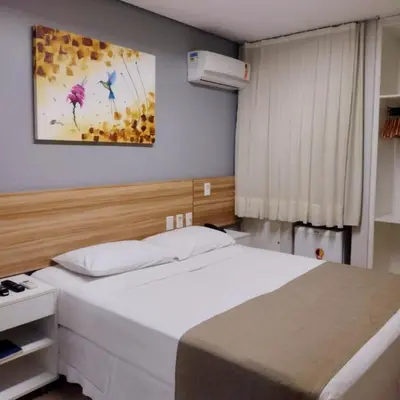 Uma cama ou camas num quarto em Hotel Três Caravelas