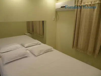 Uma cama ou camas num quarto em Porto de Iracema - Fortaleza houses