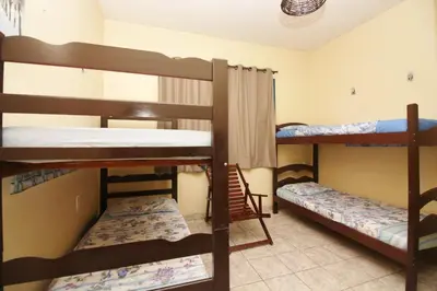 Uma cama ou camas num quarto em Pousada Fortaleza Aeroporto House
