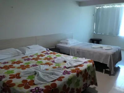 Uma cama ou camas num quarto em Hotel Litoral Fortaleza