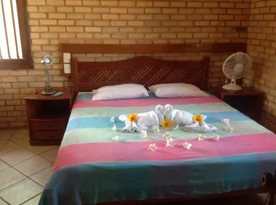 Uma cama ou camas num quarto em Hotel e Pousada Tropical Wind do Cumbuco