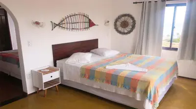 Uma cama ou camas num quarto em Pousada do Sol
