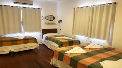 Uma cama ou camas num quarto em Pousada do Sol