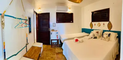 Uma cama ou camas num quarto em Pousada Tangerina