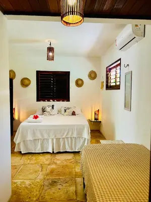 Uma cama ou camas num quarto em Pousada Tangerina