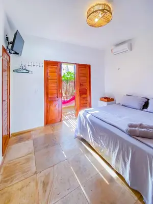 Uma cama ou camas num quarto em BEACH VILLA Camurupim