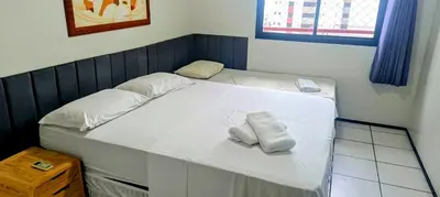 Uma cama ou camas num quarto em Excelente apto 2 quartos com vista para mar
