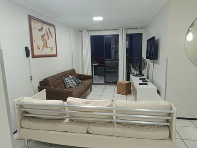Uma área de estar em Excelente apto 2 quartos com vista para mar