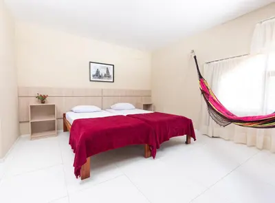 Uma cama ou camas num quarto em Dei Fiori Guaramiranga