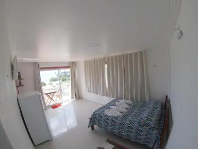 Uma cama ou camas num quarto em Flat com Varanda e Vista Mar