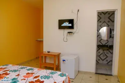 Uma televisão e/ou sistema de entretenimento em Pousada aconcheg'us