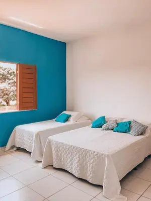 Uma cama ou camas num quarto em Mansão Beberibe