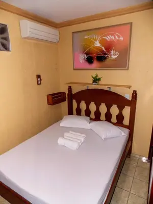 Uma cama ou camas num quarto em Léa Pousada