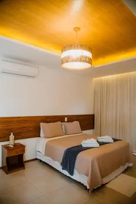Uma cama ou camas num quarto em Junduh Brasil Pousada e Restaurante