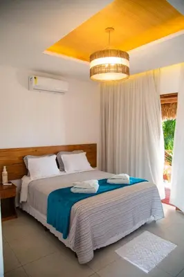Uma cama ou camas num quarto em Junduh Brasil Pousada e Restaurante