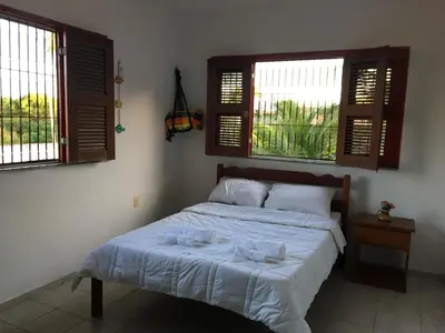 Uma cama ou camas num quarto em Beach House Paracuru - Casa da Gabi