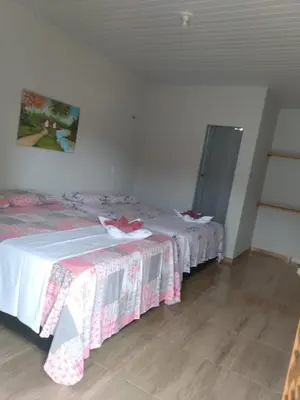 Uma cama ou camas num quarto em Pousada Caminho do Paraíso