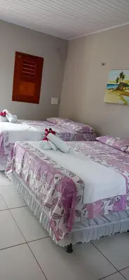 Uma cama ou camas num quarto em Pousada Caminho do Paraíso