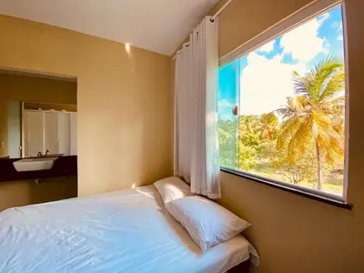 Uma cama ou camas num quarto em Casa em flecheiras com piscina