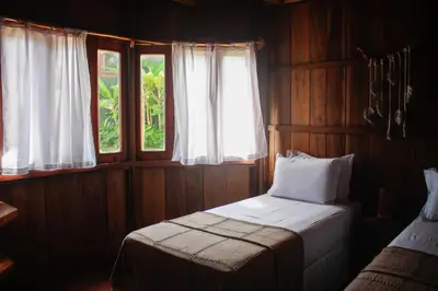 Uma cama ou camas num quarto em Pousada Jardim do vento