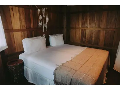 Uma cama ou camas num quarto em Pousada Jardim do vento