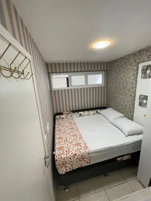 Uma cama ou camas num quarto em Apartamento com Vista para o Mar Último Andar