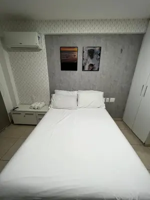 Uma cama ou camas num quarto em Apartamento com Vista para o Mar Último Andar