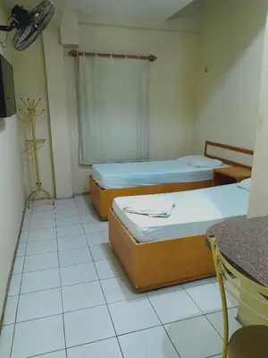 Uma cama ou camas num quarto em Tahen Hotel