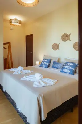 Uma cama ou camas num quarto em Vila Harmonia sua casa na Praia do Preá