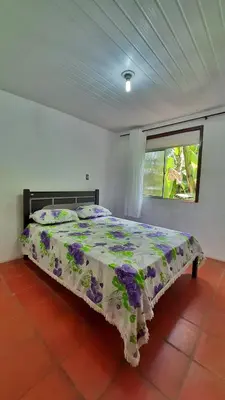 Uma cama ou camas num quarto em Chalé Verdelândia Guaramiranga - Casas com 2, 3 e 4 quartos