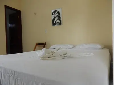 Uma cama ou camas num quarto em Pousada Brisa da Canoa