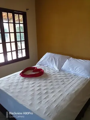 Uma cama ou camas num quarto em Chalé Bella Vista