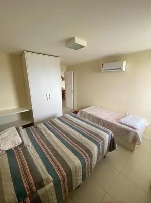 Uma cama ou camas num quarto em TerraMaris Apartamento Beira Mar Pé na areia