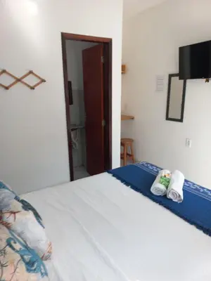 Uma cama ou camas num quarto em Hospedaria da Praia Fortaleza