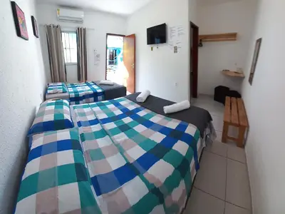 Uma cama ou camas num quarto em Hospedaria da Praia Fortaleza