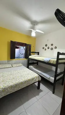 Uma cama ou camas num quarto em Residência Tatiane canoa