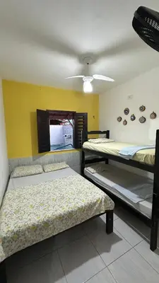 Uma cama ou camas num quarto em Residência Tatiane canoa