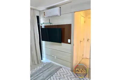 Uma televisão e/ou sistema de entretenimento em Landscape Flat Charmoso Condomínio na Beira Mar
