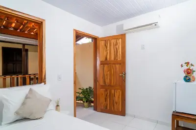 Uma cama ou camas num quarto em Pousada Zé Patinha