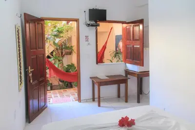 Uma cama ou camas num quarto em Pousada Zé Patinha