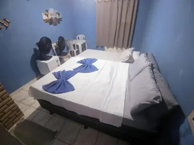 Uma cama ou camas num quarto em Pousada Casa da Perla