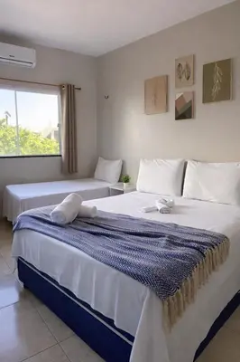 Uma cama ou camas num quarto em Praieiro pousada